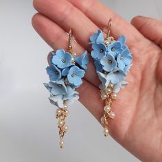 https://purplebeestudio.etsy.com Handmade unique polymer clay chandelier earrings in sky blue colour. The polymer clay flowers are made by me without using any molds. These very elegant earrings will become your favorits for many occasions day or night. Earrings made with brass ear wire. The earrings are very light and comfortable to wear all day. SHIPPING: Your order will be dispatched in a securely packed cardboard box. Product care:  - To ensure the product quality and durablility, avoid cont Blue Dangle Flower Earrings For Wedding, Handmade Blue Bridal Earrings For Wedding, Handmade Blue Flower Earrings For Wedding, Handmade Light Blue Wedding Earrings, Wedding Dangle Jewelry In Polymer Clay, Handmade Flower Polymer Clay Earrings For Wedding, Delicate Blue Flower Earrings For Wedding, Polymer Clay Flower Drop Earrings For Wedding, Handmade Flower Dangle Jewelry In Polymer Clay