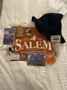 an assortment of items are laid out on top of a white bed sheet that says salem massachusetts