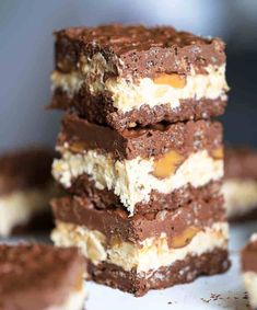 no bake chocolate caramel nutty crunch bars stacked on top of each other