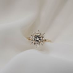 ✥ Introducing our stunning 1.05CT Round Cut Cluster Moissanite Diamond Engagement Ring, a captivating symbol of eternal love and beauty. At its center sparkles a dazzling round-cut moissanite, surrounded by a cluster of round and marquise-cut diamonds, creating a mesmerizing display of brilliance and elegance. The intricately crafted band, crafted in lustrous 14K white gold, adds a touch of sophistication to this enchanting piece. With its timeless design and exquisite detailing, this ring is su Floral Engagement Ring, Diamond Cluster Engagement Ring, Moissanite Necklace, Types Of Diamonds, Cluster Engagement Ring, Moissanite Earrings, Jewelry Images, Round Moissanite, Moissanite Wedding Bands