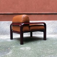 a brown chair sitting on top of a cement floor