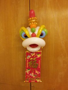 an inflatable chinese new year's decoration hanging on a door way with wood paneling