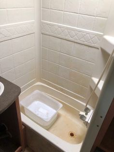 a bathroom with a sink, toilet and bathtub in the middle of the room