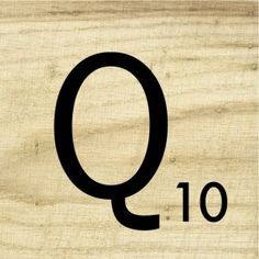 the word q is written in black on a wooden background with an oval - shaped frame