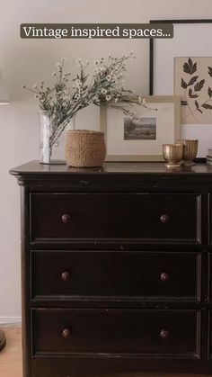 an old dresser has flowers and pictures on it