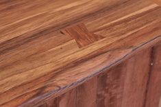 a close up of a wooden counter top with wood grain patterning on the edge