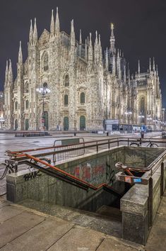 the cathedral is lit up at night with its lights on