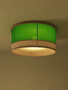 a green lamp shade hanging from the ceiling