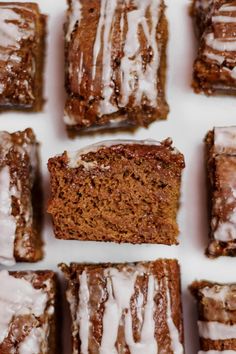 several slices of glazed brownies with icing on them