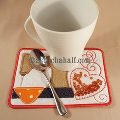 there is a cup and spoon on the place mat with a spoon next to it