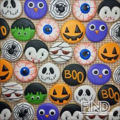 halloween decorated cookies are arranged on a table