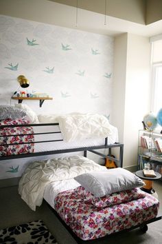 a bedroom with bunk beds and pillows on the floor