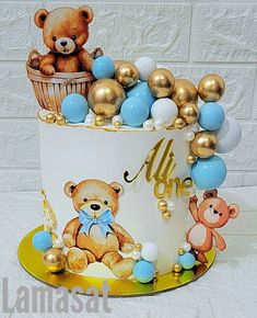 a teddy bear themed cake with gold and blue decorations