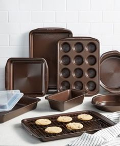 an assortment of baking pans and cookies on a counter