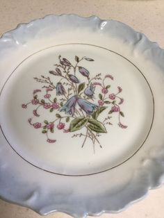 a white plate with flowers painted on it