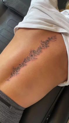 Spine Tattoos Cute But Cool Tattoos, Spine Tattoos For Women Growth, Slime Tattoos For Women, Minimalistic Back Tattoos For Women, Free Spirited Tattoos Ideas, Colorful Behind The Ear Tattoo Ideas, Bestie Hip Tattoos, Single Line Spine Tattoo, Women’s Simple Tattoos