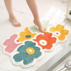 a person standing on top of a bathroom rug