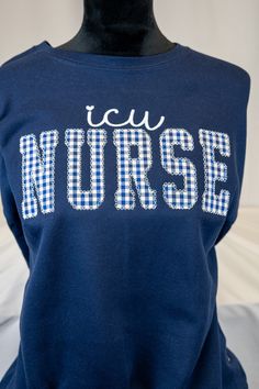 Elevate your role as an ICU Nurse with our beautifully crafted embroidered sweatshirt, featuring a delicate floral applique accentuating the word 'Nurse'. Designed with comfort and style in mind, this sweatshirt is a perfect blend of functionality and fashion. Whether you're providing critical care to patients or taking a well-deserved break, this sweatshirt ensures you do it with grace and professionalism. The intricate floral applique symbolizes the compassion and dedication inherent in ICU nu Cotton Sweatshirt With Machine Embroidery For College, Fall Nursing Sweatshirt With Crew Neck, Machine Embroidered Crew Neck Top For College, Crew Neck Top With Machine Embroidery For College, Cotton Sweatshirt For Nursing In Fall, Cotton Nursing Sweatshirt For Fall, Cotton Nursing-friendly Relaxed Fit Sweatshirt, Cotton Relaxed Fit Nursing Sweatshirt, Nursing Cotton Sweatshirt With Crew Neck