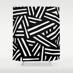 a black and white shower curtain with an abstract pattern on the front, featuring diagonal lines