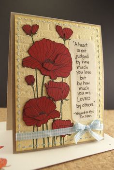 a card with red flowers on it and a poem written in the bottom right corner