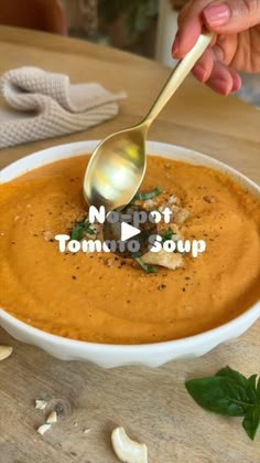 a person is spooning some soup out of a bowl