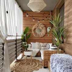 a living room filled with lots of furniture and plants on top of a wooden wall