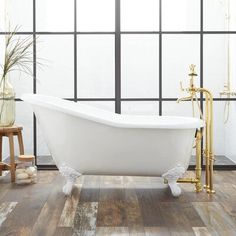 a white bath tub sitting on top of a wooden floor