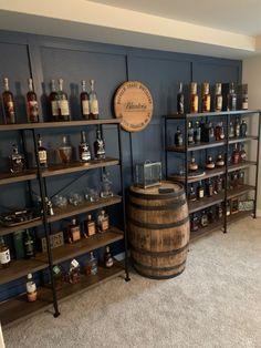 a room filled with lots of bottles and shelves full of liquor on top of wooden barrels