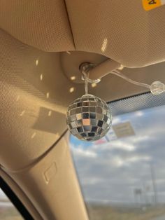 a disco ball hanging from the ceiling in a car