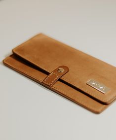 The Del Mar is a long wallet that has plenty of room for all of your cards and cash! It features 6 card slots and two cash pockets that will fit unfolded bills. It also has a zippered pocket for all of your change and loose items. The snap closure allows for quick opening and closing of the wallet. 100% saddle-stitched Full-grain leather Waxed and burnished edges Solid brass hardware Premium Riri zipper Ritza 25 Tiger Thread Closed Dimensions: 7.5"w x 4"h If you would like a leather or thread co Medium Brown, Long Wallet, Brass Hardware, Full Grain Leather, Continental Wallet, Snap Closure, Solid Brass, Saddle, Card Slots