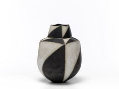 a black and white vase sitting on top of a table