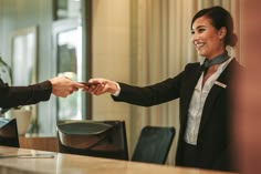 two business people shaking hands in an office