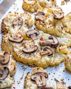 the pizza is covered with mushrooms and cheese on the baking sheet, ready to be eaten