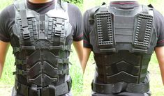 the back and side view of a man in black leather armor with multiple rows of spikes on his chest