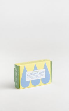 a soap bar sitting on top of a white table next to a blue and yellow box