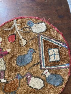 a round rug with animals and birds on it