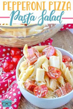 pepperoni pizza pasta salad in a white bowl on a red and white tablecloth