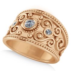 a gold ring with two blue stones on it's center and an intricate design in the middle