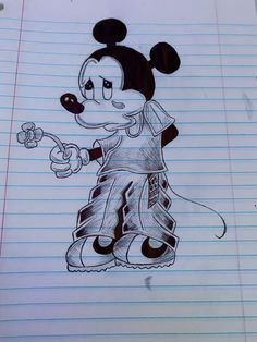 a drawing of mickey mouse on lined paper