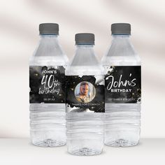 three bottled water bottles with the name john's birthday on them, sitting next to each other