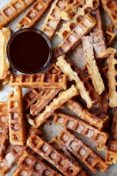 waffles with syrup and powdered sugar on the side, ready to be eaten