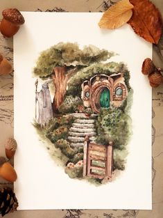 a drawing of a hobbot house surrounded by leaves and acorns on a piece of paper