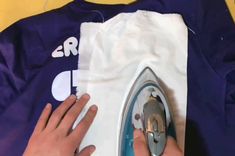 someone is using an iron on a t - shirt