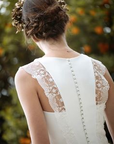 the back of a woman's dress with pearls on it