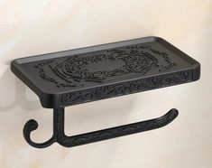 a black metal shelf with an ornate design on it