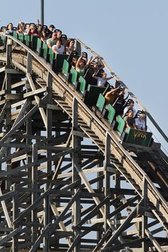 a roller coaster with many people riding it