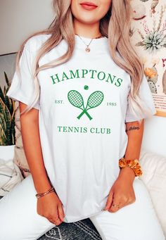 a woman with blonde hair wearing a t - shirt that says hamptons tennis club