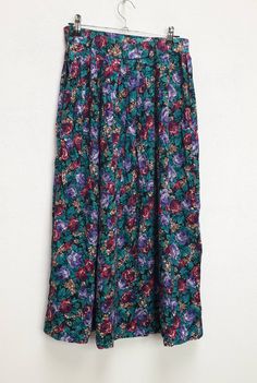 "a vintage green and purple floral high-waisted long skirt ✿ IMPORTANT INFORMATION: * excellent vintage condition * material: 100% rayon * size: extra-small - please check exact measurements below (they're there for your benefit!) * garment care: machine washable * made in the u.s.a. ✿ MEASUREMENTS (taken while item is lying flat, some measurements will need to be doubled): * length: 31\" (79cm) * waist: 12.5\" (32cm) * hips: 29\" (74cm) ✿ free UK shipping on orders over £100 with code STRAWBERR Green Flared Maxi Skirt With Floral Print, Green Flared Skirt With Floral Print, Green Floral Print Flowy Skirt, Bohemian Purple Floral Print Bottoms, Bohemian Purple Bottoms With Floral Print, Vintage Purple Lined Skirt, Bohemian Purple Floral Print Skirt, Green Floral Print Relaxed Skirt, Vintage Green Tiered Skirt