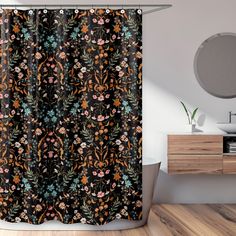 a black shower curtain with colorful flowers on it