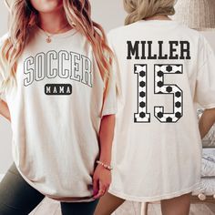 Show your team spirit with this Custom Soccer Mom Shirt, personalized with your kids' names and jersey numbers. The perfect Coquette Soccer Mom gift for any soccer lover, this stylish shirt combines flair and family pride in one unforgettable piece 🤍 ♥ DESCRIPTION: This is a Comfort Colors Unisex t-shirt that is 100% ring-spun cotton, soft-washed, garment-dyed fabric brings extra coziness to your wardrobe while the relaxed fit makes it an excellent daily choice. The double-needle stitching thro Customizable White T-shirt For Sports Season, Personalized White Sporty T-shirt, Customizable White Fan Apparel T-shirt, Varsity Crew Neck T-shirt For Team Events, Personalized Cotton T-shirt For Game Day, Collegiate White Sublimation Design With Name Print, Customizable Short Sleeve Tops For Team Events, Customizable Crew Neck Tops For Team Events, White Varsity Sublimation Design Short Sleeve